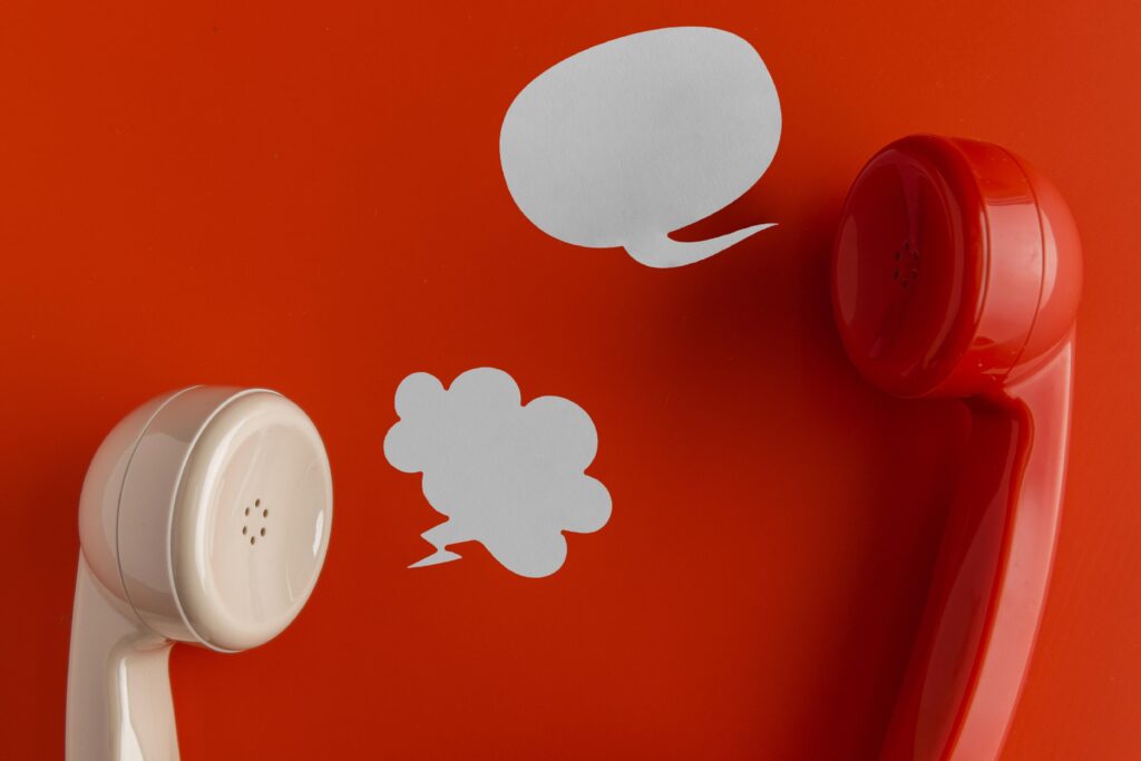top view telephone receivers with chat bubbles